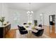 Bright dining room featuring a chandelier, shutters, and a white marble table with seating for six at 4200 Joslyn Ln, Lady Lake, FL 32159