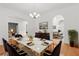 Elegant dining room with marble table, seating for six, modern lighting, and hardwood floors at 4200 Joslyn Ln, Lady Lake, FL 32159