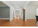 Elegant hallway with hardwood floors, neutral walls, and natural light from a skylight at 4200 Joslyn Ln, Lady Lake, FL 32159