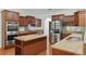 Modern kitchen featuring an island, granite counters, stainless appliances, and custom cabinetry at 4200 Joslyn Ln, Lady Lake, FL 32159