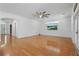 Spacious living room featuring pristine hardwood floors and a modern ceiling fan at 4200 Joslyn Ln, Lady Lake, FL 32159
