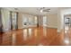 Bright living room with wood floors, large windows, and ceiling fan at 4200 Joslyn Ln, Lady Lake, FL 32159