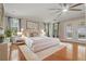 Spacious main bedroom with wood floors, ceiling fan, and a king-size bed at 4200 Joslyn Ln, Lady Lake, FL 32159