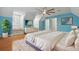A beautiful main bedroom boasting hardwood floors, ensuite bathroom, and a ceiling fan at 4200 Joslyn Ln, Lady Lake, FL 32159