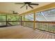 View of a screened patio area featuring a wooden deck and offering views of the backyard at 4200 Joslyn Ln, Lady Lake, FL 32159