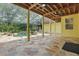 Inviting screened-in pool area with a stone patio, tropical landscaping, and covered outdoor living space at 4200 Joslyn Ln, Lady Lake, FL 32159