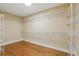 Spacious walk-in closet featuring a wood floor and ample shelving for organization and storage at 4200 Joslyn Ln, Lady Lake, FL 32159