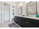 This bathroom has a double vanity with modern fixtures, unique decor, and lots of storage at 464 W Plant St, Winter Garden, FL 34787
