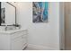 Bathroom vanity with white cabinets, gray tile, and modern finishes at 464 W Plant St, Winter Garden, FL 34787