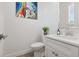 Charming powder room features modern fixtures, a decorative mirror, and bright natural light at 464 W Plant St, Winter Garden, FL 34787