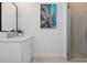 Modern bathroom with white cabinets, artwork, glass shower, and tile flooring at 464 W Plant St, Winter Garden, FL 34787
