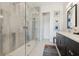 This bathroom has a glass enclosed shower with dual shower heads and gray and white walls at 464 W Plant St, Winter Garden, FL 34787