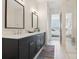 This spacious bathroom features a double vanity, stylish mirrors, and calming paint at 464 W Plant St, Winter Garden, FL 34787