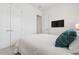 Light and bright bedroom with modern finishes, flat screen television, and double closets at 464 W Plant St, Winter Garden, FL 34787