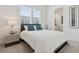 This bedroom features a large bed, bright light, and access to the bathroom at 464 W Plant St, Winter Garden, FL 34787
