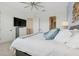 This bedroom boasts a large bed, neutral walls and an ensuite bathroom and walk in closet at 464 W Plant St, Winter Garden, FL 34787