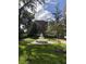 Beautiful courtyard with a tiered fountain, lush green grass, and manicured landscaping in a serene setting at 464 W Plant St, Winter Garden, FL 34787