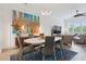Bright dining room with an abstract painting, modern lighting fixture, and view of a large window at 464 W Plant St, Winter Garden, FL 34787