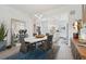 Open floor plan view of a dining room connecting to a kitchen with white cabinetry and island at 464 W Plant St, Winter Garden, FL 34787