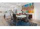 Dining room with an abstract painting, modern lighting fixture, and a view into a bright kitchen at 464 W Plant St, Winter Garden, FL 34787