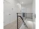 Bright hallway with modern railing and white doors at 464 W Plant St, Winter Garden, FL 34787