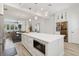 Modern kitchen with a large island, built-in microwave, and seamless flow to the dining area at 464 W Plant St, Winter Garden, FL 34787