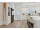 Bright kitchen features white cabinetry, stainless appliances, and a large center island with counter seating at 464 W Plant St, Winter Garden, FL 34787