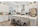 Bright, all-white kitchen featuring a large island, stainless steel appliances, and abundant natural light at 464 W Plant St, Winter Garden, FL 34787
