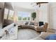 The home's living room features a large window, a modern ceiling fan, and a leather sectional at 464 W Plant St, Winter Garden, FL 34787