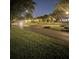 Festive neighborhood streetscape with decorative lights on trees, sidewalks, and landscaped areas at dusk at 464 W Plant St, Winter Garden, FL 34787