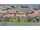 Aerial view of the community with multiple buildings near a lake and cityscape views at 5024 Shoreway Loop # 10106, Orlando, FL 32819