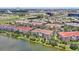 A tranquil aerial view of a lakeside community with well-maintained buildings and lush greenery at 5024 Shoreway Loop # 10106, Orlando, FL 32819