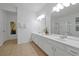 Spacious bathroom with double vanity, white cabinets, and bright lighting fixtures at 5024 Shoreway Loop # 10106, Orlando, FL 32819