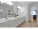Bright bathroom with double vanity, large mirrors, and an open doorway leading to the bedroom at 5024 Shoreway Loop # 10106, Orlando, FL 32819