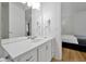 A bathroom features a white vanity with a large mirror and modern fixtures at 5024 Shoreway Loop # 10106, Orlando, FL 32819