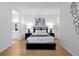 Comfortable bedroom featuring a modern bed frame, bedside lamps, and stylish wall art at 5024 Shoreway Loop # 10106, Orlando, FL 32819