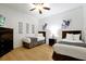 A cozy bedroom featuring two beds, modern décor, and wood flooring at 5024 Shoreway Loop # 10106, Orlando, FL 32819