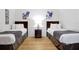 Charming bedroom featuring two twin beds, a wooden nightstand, and stylish artwork at 5024 Shoreway Loop # 10106, Orlando, FL 32819