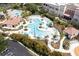 Aerial view of the community pool area with palm trees, lounge chairs, and inviting blue waters at 5024 Shoreway Loop # 10106, Orlando, FL 32819