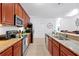 Well-equipped kitchen featuring granite countertops, wooden cabinetry, and stainless steel appliances at 5024 Shoreway Loop # 10106, Orlando, FL 32819