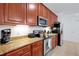 Fully equipped kitchen featuring stainless steel appliances and warm wood cabinets at 5024 Shoreway Loop # 10106, Orlando, FL 32819