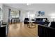 Bright living room featuring hardwood floors, modern furnishings, and large windows at 5024 Shoreway Loop # 10106, Orlando, FL 32819
