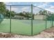 A community tennis court is surrounded by a green fence and mature trees at 546 Northbridge Dr, Altamonte Springs, FL 32714