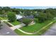 Aerial view of home with mature landscaping, beautiful lawn, and scenic lake in background at 5929 Hatteras Dr, Port Orange, FL 32127