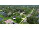 Aerial view of home nestled among lush greenery and a tranquil pond at 5929 Hatteras Dr, Port Orange, FL 32127