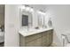 Bathroom featuring double sinks with brushed nickel fixtures and white countertops with coordinated olive cabinetry at 5929 Hatteras Dr, Port Orange, FL 32127
