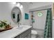 Bathroom with decorative shower curtain, large vanity, and natural light at 5929 Hatteras Dr, Port Orange, FL 32127