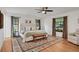 Main bedroom with large bed, hardwood floors, and neutral decor at 5929 Hatteras Dr, Port Orange, FL 32127