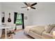 Bedroom with ceiling fan, natural light, desk, and guitar at 5929 Hatteras Dr, Port Orange, FL 32127