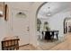 Inviting entryway featuring decorative arched doorway and view of dining area with natural light at 5929 Hatteras Dr, Port Orange, FL 32127